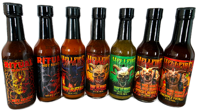 Row of hot sauce bottles with various labels on a black background